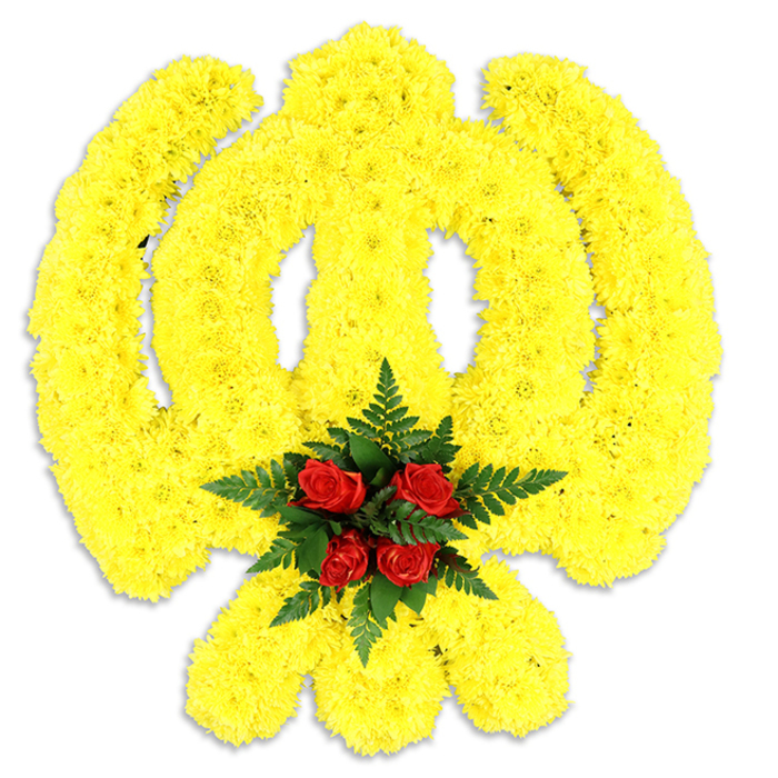 Framed by a clean white field, this large floral Khanda commands attention with formal clarity: every line of the sacred Sikh emblem is articulated in compact, bright yellow chrysanthemum blooms. The petals of the chrysanthemums are arranged in dense, rhythmic rows to form the circular chakram, the central double-edged khanda blade, and the two crossed kirpans, producing a soft, tactile surface that appears slightly sculpted and casts a modest grey shadow beneath. At the emblem's centre a regimented cluster of five deep red roses provides a ceremonious focal point; their velvet-rich texture and deeper hue are deliberately set against a collar of deep green fern leaves, whose linear fronds add structure and a cooling contrast. The composition reads as both symbolic and architectural: the yellow mass suggesting warmth and remembrance, the red core communicating solemn respect, and the green foliage offering a quiet, grounding frame. In the studio light the arrangement's textures are clear-the chrysanthemums' frilly edges, the roses' layered petals and the fern's glossy serration-while the overall scent is a restrained blend of rose warmth tempered by fresh green notes. Intended for formal remembrance settings, gurdwara halls, funeral services or civic commemorations around Mitcham-from Cricket Green ceremonies to moments outside local community centres-this piece balances religious reverence with floristry craft. Its solidity and thoughtful contrast make it a respectful, visually precise tribute appropriate for occasions of remembrance and cultural observance.
